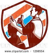Vector Clip Art of Retro Male Barber Cutting a Client's Hair with Clippers in a Barber Pole Striped Shield by Patrimonio