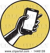 Vector Clip Art of Retro Woodcut Hand Holding a Smart Phone in a Yellow and Black Circle by Patrimonio