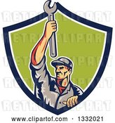 Vector Clip Art of Retro Male Mechanic Holding a Wrench Above His Head in a Blue White and Green Shield by Patrimonio