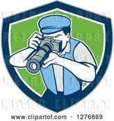 Vector Clip Art of Retro Male Photographer Taking Pictures in a Gray Blue White and Green Shield by Patrimonio