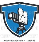 Vector Clip Art of Retro Movie Camera in a Blue Shield by Patrimonio